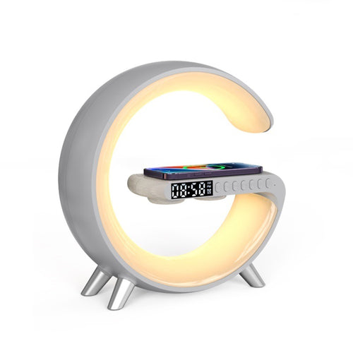 Aura G G-shaped lamp in light grey with warm white glow and phone charging